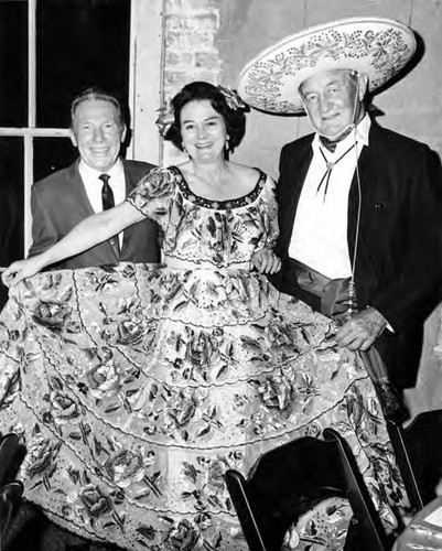 Sam Yorty with a woman in Spanish dress and a man in sombrero