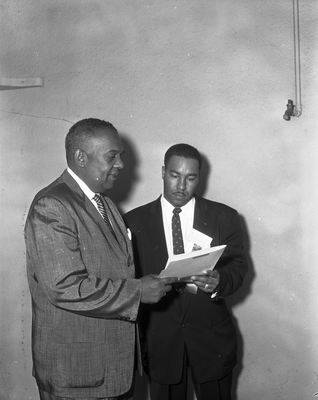 Walter Taylor (left) and man looking at document