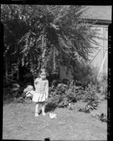 Three-year-old Rosita Dee Cornell standing outside pointing at something on the ground, California, 1934