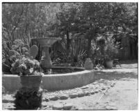 Avila Adobe, view of patio with fountain and watering can, Olvera Street, Los Angeles, 1934