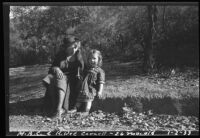 Ruth Iva Cornell with her daughter, Rosita Dee, seated on the ground outside, California, 1933