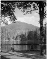 View of a tree-covered mountain across a lake near Segovia, Spain, 1929