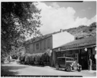 Outdoor café and automobile in front of a shop, Balaruc-le-Vieux, France, 1929