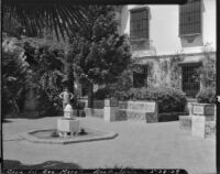 Boy on a plaza at Casa del Rey Moro, view of fountain and benches, Ronda, Spain, 1929