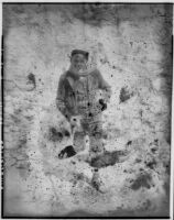 Man wearing a scarf standing on rocky ground, Europe, 1920s