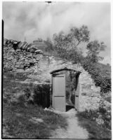 Doorway in a stone wall in the countryside, Italy, 1929