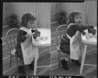 Two-year-old Rosita Dee Cornell wearing an apron and playing with a tiny tea set, California, 1933