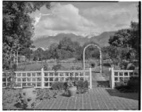 E. N. Bender residence, view towards patio, trellis fence and lawn with lily pond beyond, Pasadena, 1931