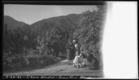 Ralph D. Cornell family gathered in front of Blueblossom bushes, Sierra Madre, 1932