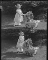 Rosita Dee Cornell pushing a baby carriage outdoors, California, 1931