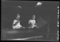 Baby Rosita Dee Cornell sitting on a couch with another baby, California, 1932