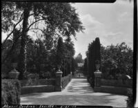 Gardens at Alcázar of Seville, view of benches framing a circular space, Seville, Spain, 1929