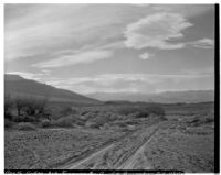 Unpaved desert road and mountains, Death Valley, 1927