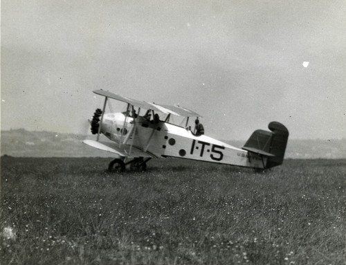 Military training plane on grass field North Island, c. 1937