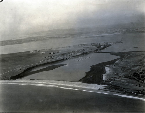 Aerial view of a military squadron flying over North Island, c. 1930