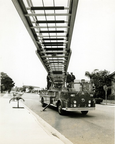 New 1970 Crown fire truck with 100’ aerial ladder parked on D Avenue at Sixth Street, 1970