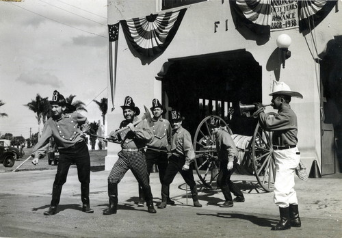 Chief Thompson and other Coronado firefighters pulling a “horse drawn hose cart” during the Hotel del Coronado’s 50th anniversary celebration, 1938