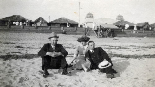 Three adults sitting on beach, Tent City, Coronado, Calif. c. 1910