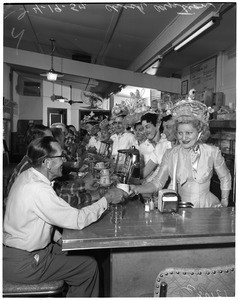 Waitress at Rite Spot restaurant wear Easter bonnets, 1957