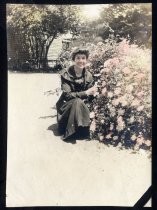 Young woman posing with flowering bush