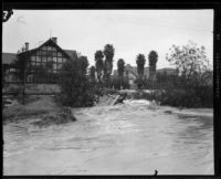 Rainstorm flooding at the intersection of Wilshire Boulevard and Mariposa Ave., Los Angeles, 1927