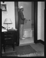 Detective Sergeant Sibley standing near the bathtub where Gladys G. Fair's body was found, Long Beach, 1935