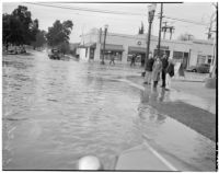 Group gathered at flooded streets caused by heavy rainstorms, January 1940