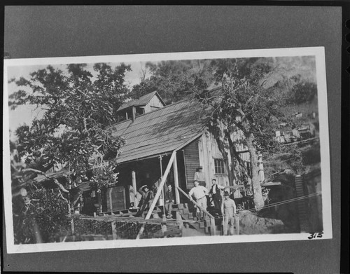 The staff standing on the porch and steps of the hospital at the Kern River Headquaters Camp at Kern River #1 Hydro Plant
