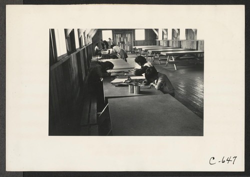 Tanforan Assembly Center, San Bruno, Calif.--In the art school at this assembly center. These evacuee children are remaining after hours to continue their creative work. Photographer: Lange, Dorothea San Bruno, California