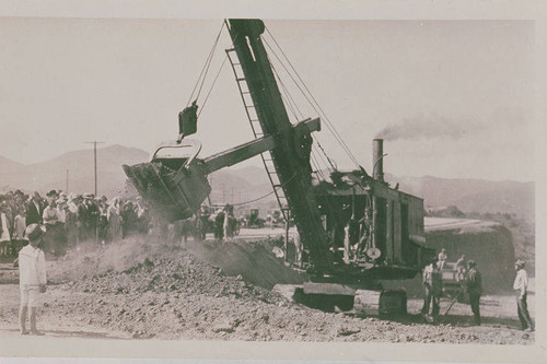 Crowd near a steam shovel at the construction site of Beverly Blvd. (now Sunset Blvd.) in Pacific Palisades, Calif