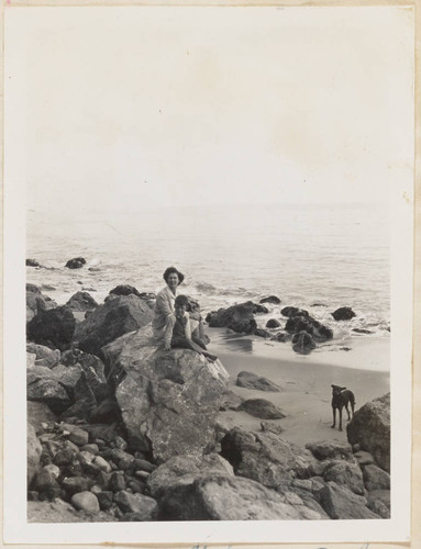 Woman, child and dog at beach