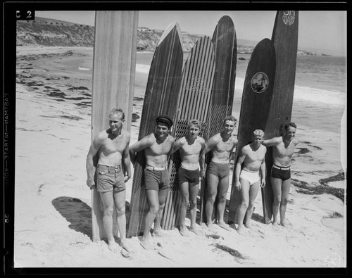 Men with surfboards posing on the beach, Santa Monica
