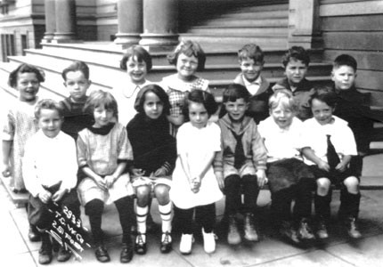 School children seated on steps of Cornell School