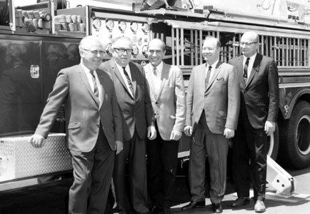 City Council members posed in front of hook and ladder truck