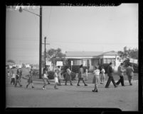 Labor union members picketing home of glass manufacturer Samuel Moss as neighborhood children picket them in Los Angeles, Calif., 1947
