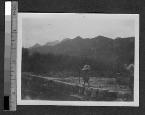 Two men crossing a river, Ing Tai, Fujian, China, ca. 1910