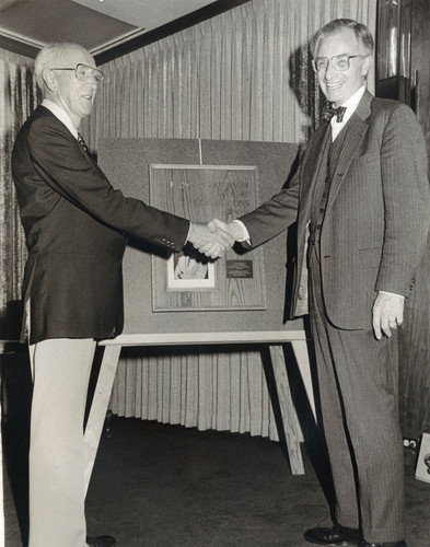 A photograph of Floyd R. Erickson and Ellis McCune shaking hands at the Dedication of the Special Collections Room