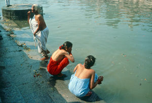 Here Hindu women are involved in cleaning rituals at the holy Bagmati River in Kathmandu, Nepal
