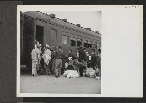 Transferees from the Topaz Center are here shown boarding the train (trip 15) for their new home at Tule Lake. Photographer: Mace, Charles E. Topaz, Utah