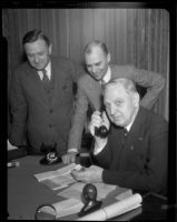 C. A. Holzer and H. W. Beck watch as Mayor Porter places the call to New York to initiate coast-to-coast flights, Los Angeles, 1932