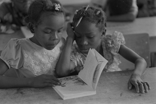 Students in a classroom reading a book, San Basilio de Palenque, ca. 1978