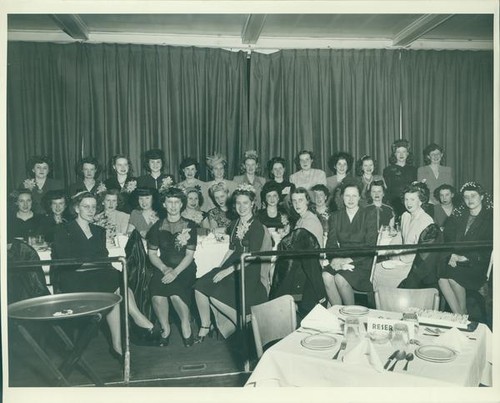 Group of women gathered around dining tables
