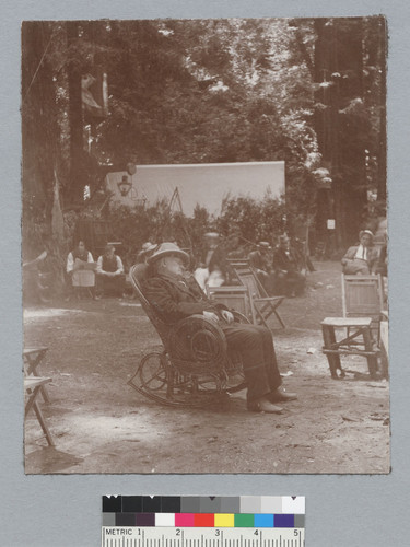 Man sleeping in rocking chair, Bohemian Grove. [photographic print]