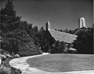 View of Stone chapel with ivy with a building in the far background at Forest Lawn Memorial Park