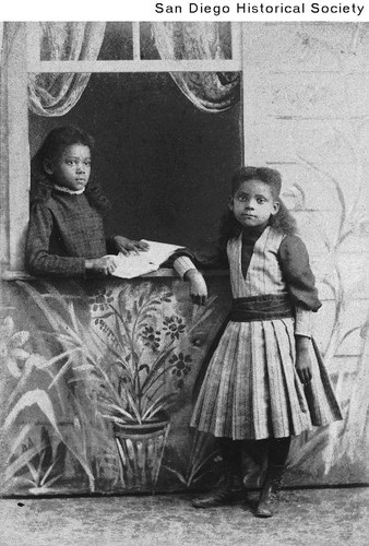 Two young African American girls near an open window