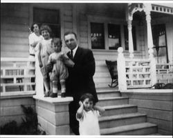 Angela, Mary, Tom, and Ruth Agius standing on the front porch of 210 West Street in Petaluma, California, with cousin Louie, about 1926