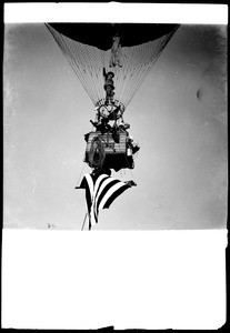 Balloon showing George B. Harrison standing on concentrating ring, Clifford B. Harmon peering over the side with Mrs. Paulhan and a companion at the Dominguez Air Meet, 1910