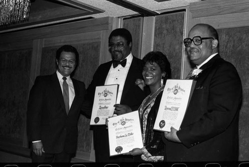 Rosey Grier, Stephanie Lee-Miller, and Rev. E.V. Hill posing with certificates of achievement, Los Angeles, 1985
