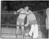 Ceferino Garcia, champion boxer from the Philippines, with his trainer in the ring, Los Angeles, circa 1938