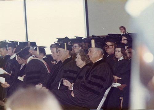 Students and guests in academic regalia, Bob Hope standing, Mrs. Harnish in front of him